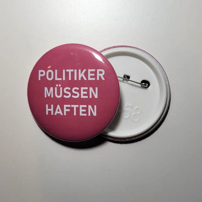 Button "POLITIKER MÜSSEN HAFTEN"